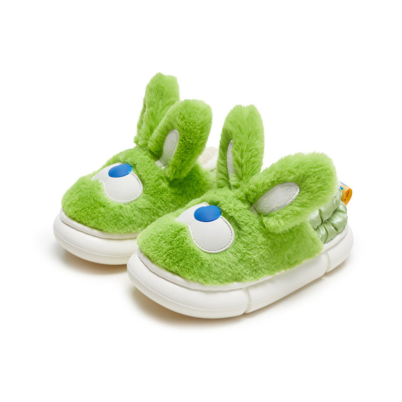 Green plush slippers with bunny ears and white sole on a white background