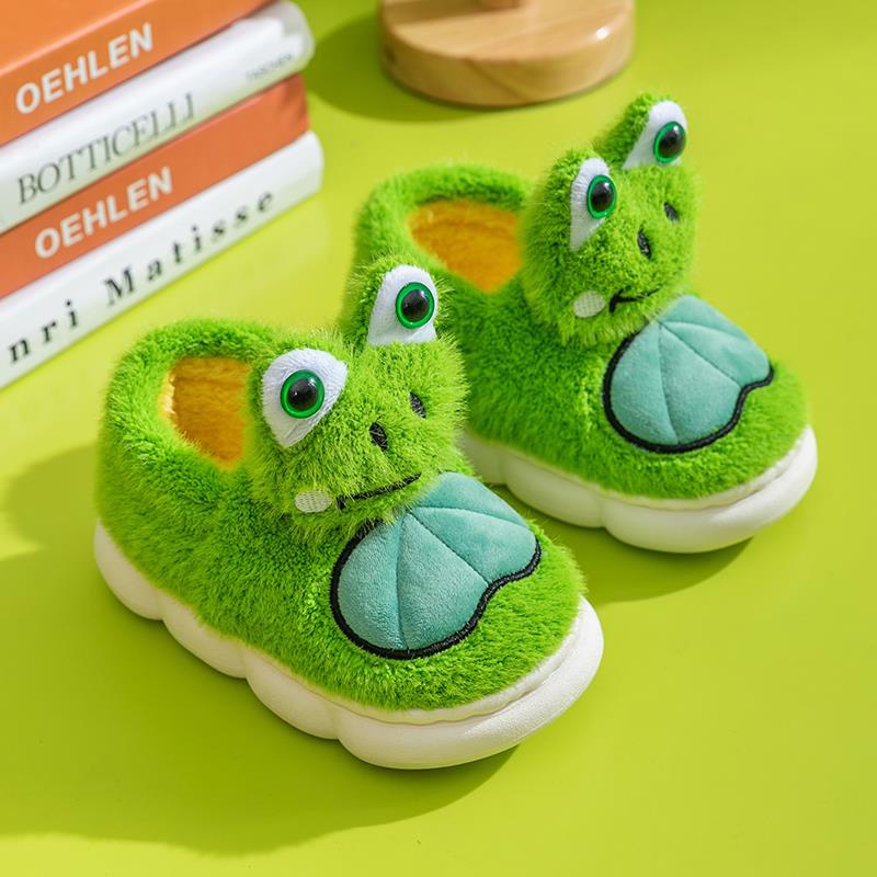 Green frog slippers on a bright green background with books in the background.