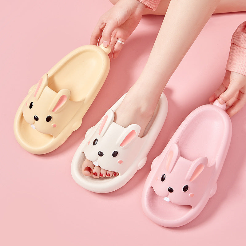 Cute rabbit-shaped slippers on a pink background