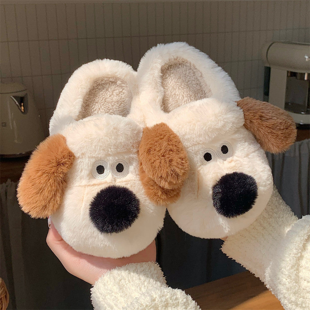 Pair of dog-shaped slippers held in front of a kitchen background
