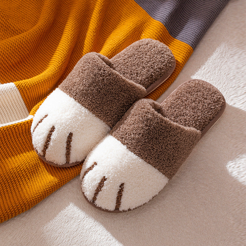 Pair of brown and white slippers on a striped fabric background