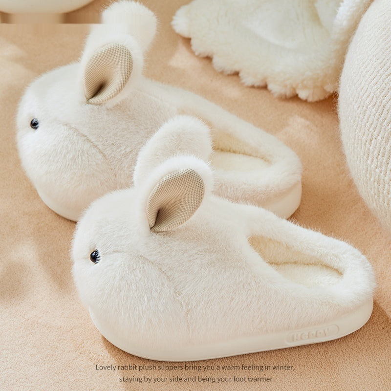 White plush rabbit slippers on a beige surface with text description.