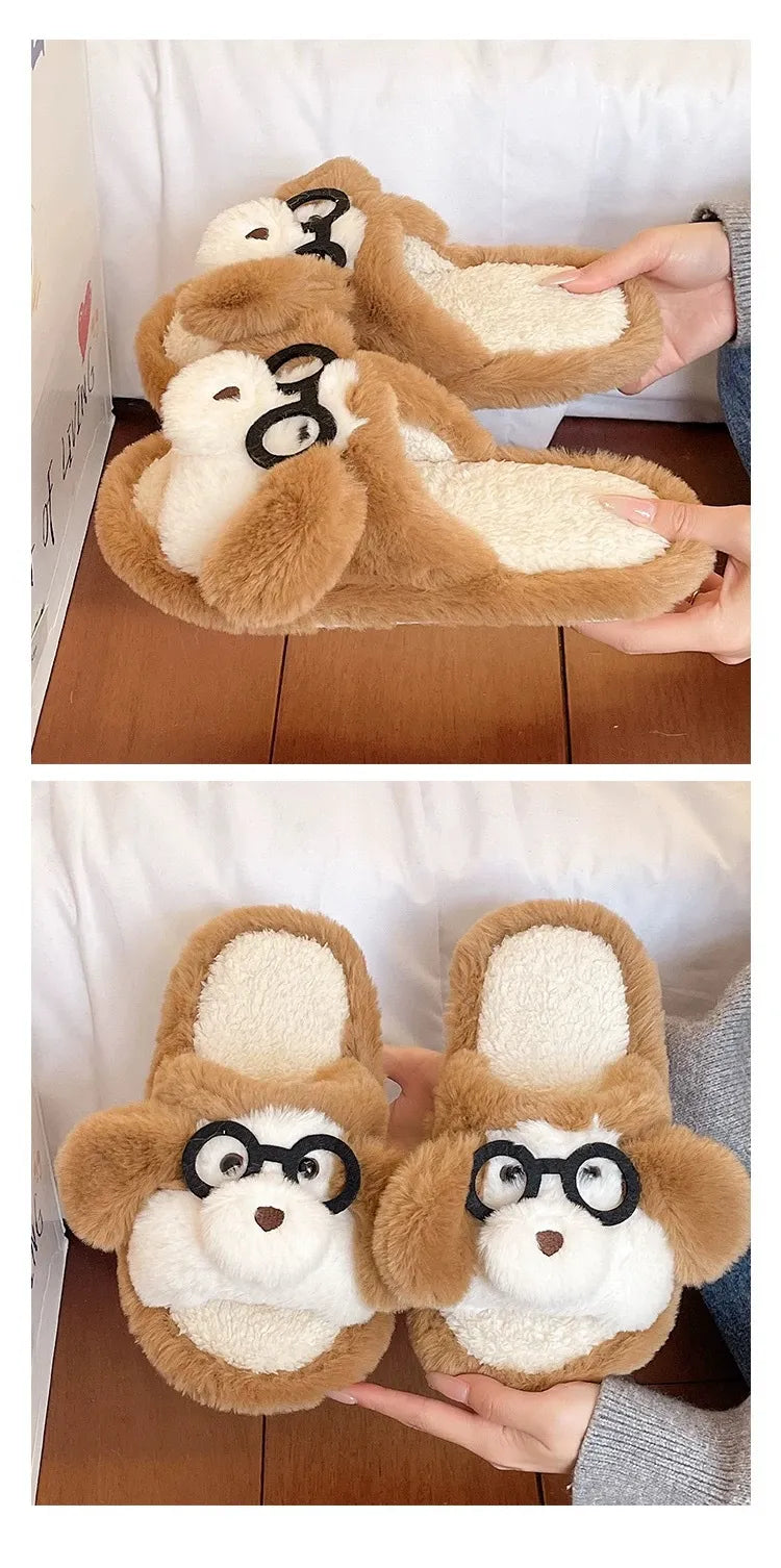 Pair of brown slippers with bear faces and glasses held by a person.