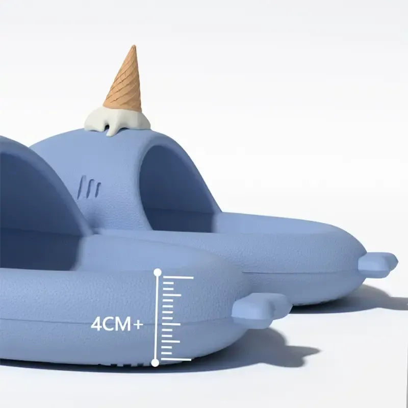 Blue narwhal-shaped toy with a cone on its head and a measurement scale indicating 4CM+