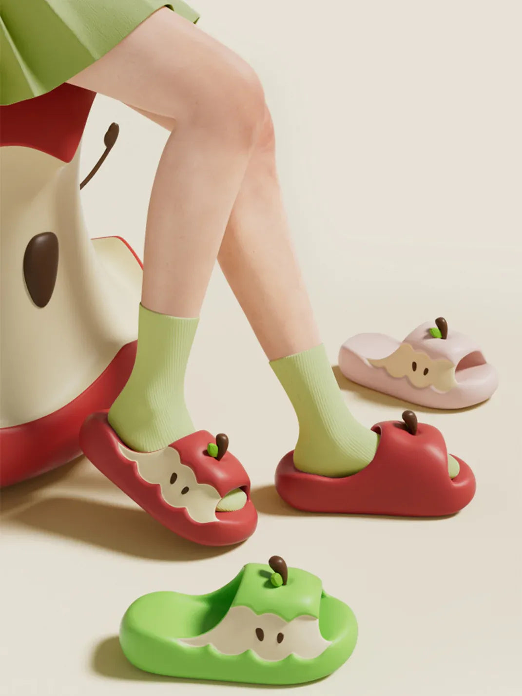 Apple novelty slipper gift set showing one red apple and one green apple slipper side by side