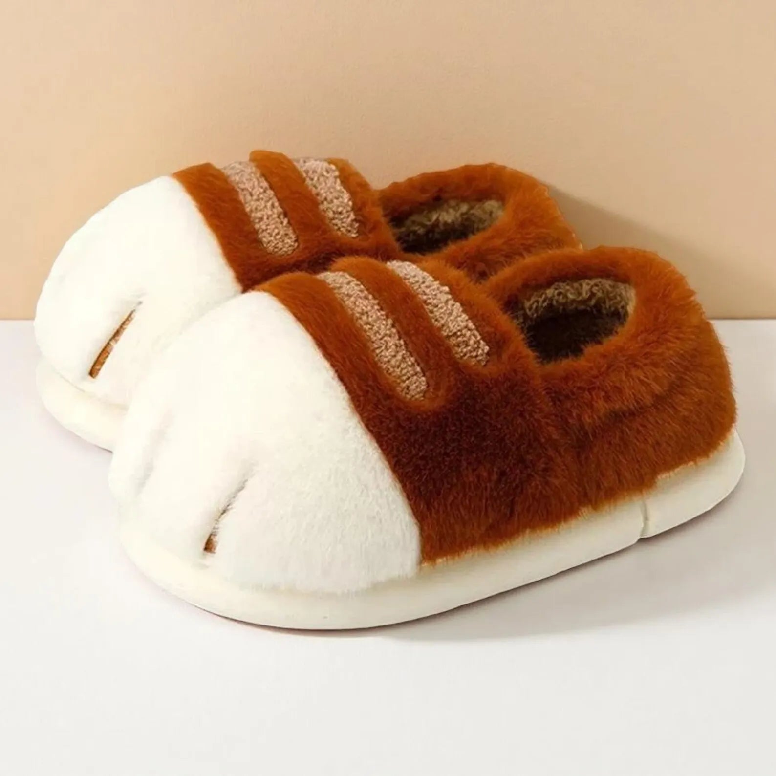 Pair of brown and white slippers on a light background