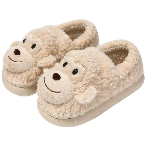 Monkey-themed slippers with a person wearing them on a neutral background