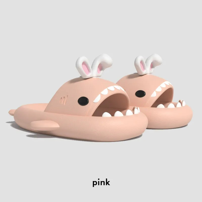 Pink sandals with bunny ears and shark teeth on a light gray background