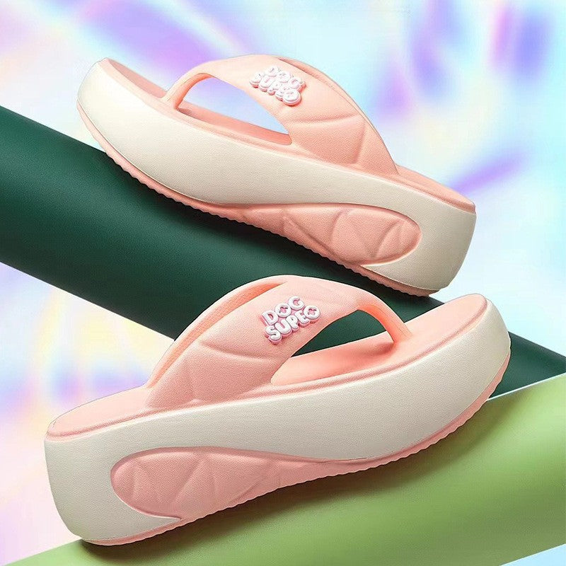 Pair of pink sandals with white soles on a colorful background
